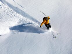 Man skiing in a yellow jacket