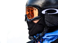 Skier in a black helmet and blue jacket