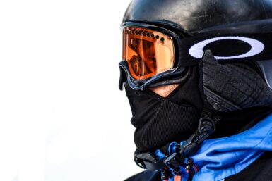 Skier in a black helmet and blue jacket