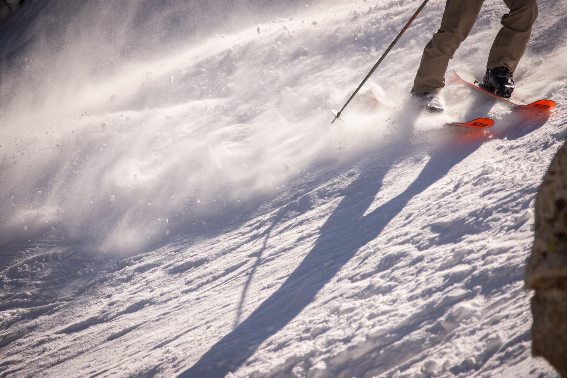skier sliding down a steep hill